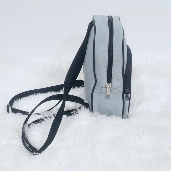 Lacoste mini backpack in a soft light blue shade with navy blue trim accents. - Picture 6 of 16